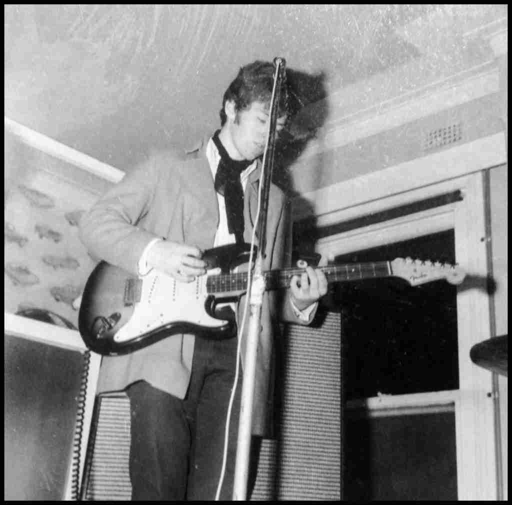 Young 60s boy with Fender Stratocaster