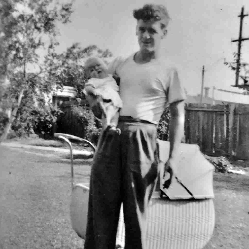 1950s man holding a baby