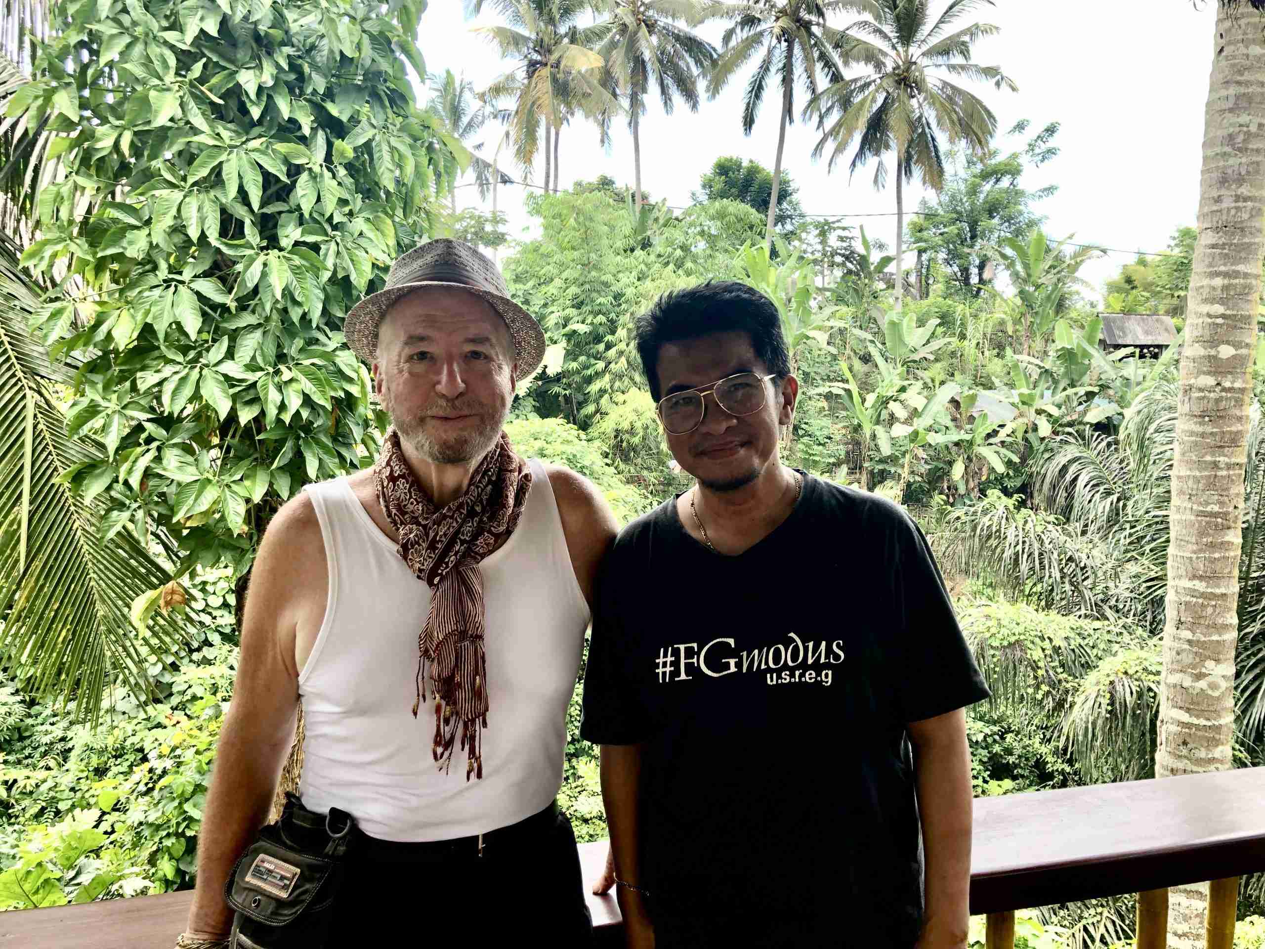 2 men in a tropical location